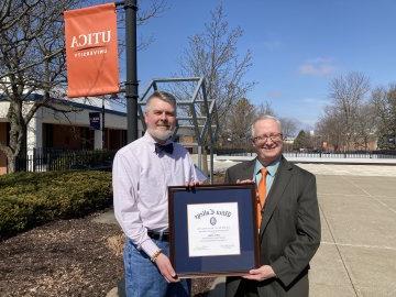 Provost Todd Pfannestiel presents the Paul Young Award to Professor Jeffrey Miller.